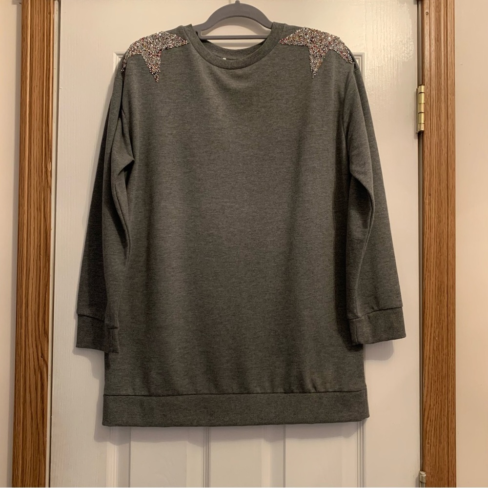 Grey long sleeve knit sweater with star embellishments on the shoulders